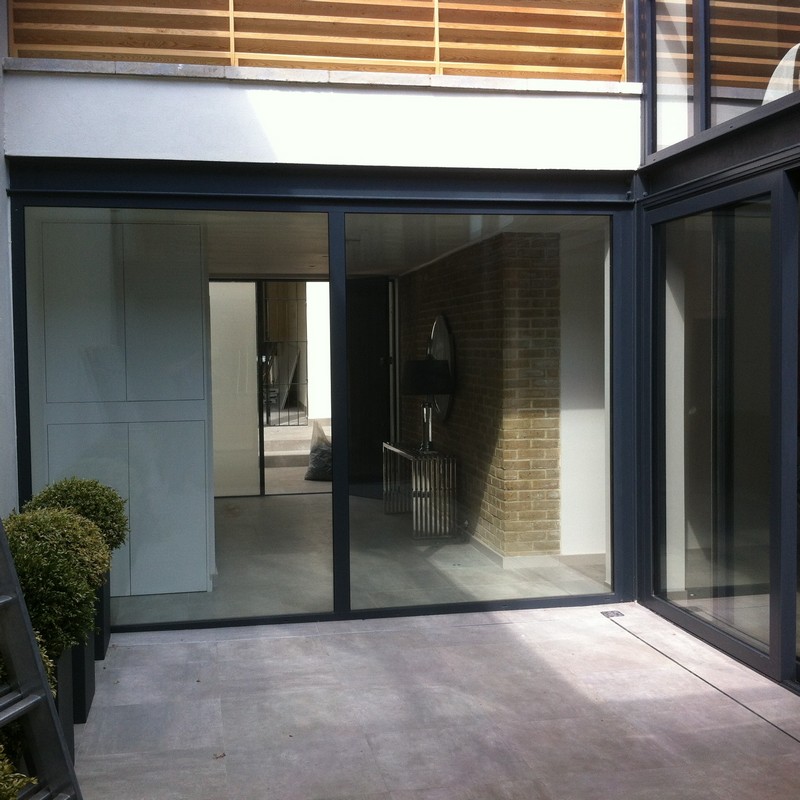 Floor-to-ceiling sliding doors opening to courtyard in Thornton Heath