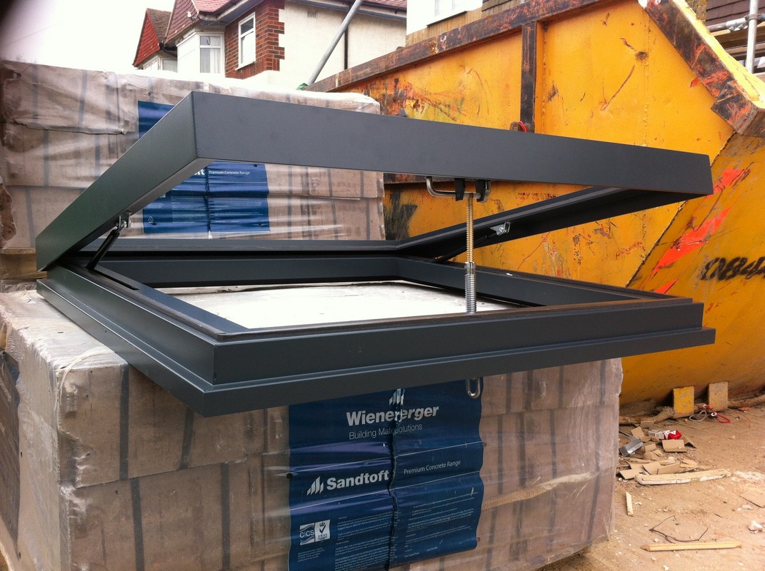 Opening flat roof skylight in anthracite grey installed in Thornton Heath