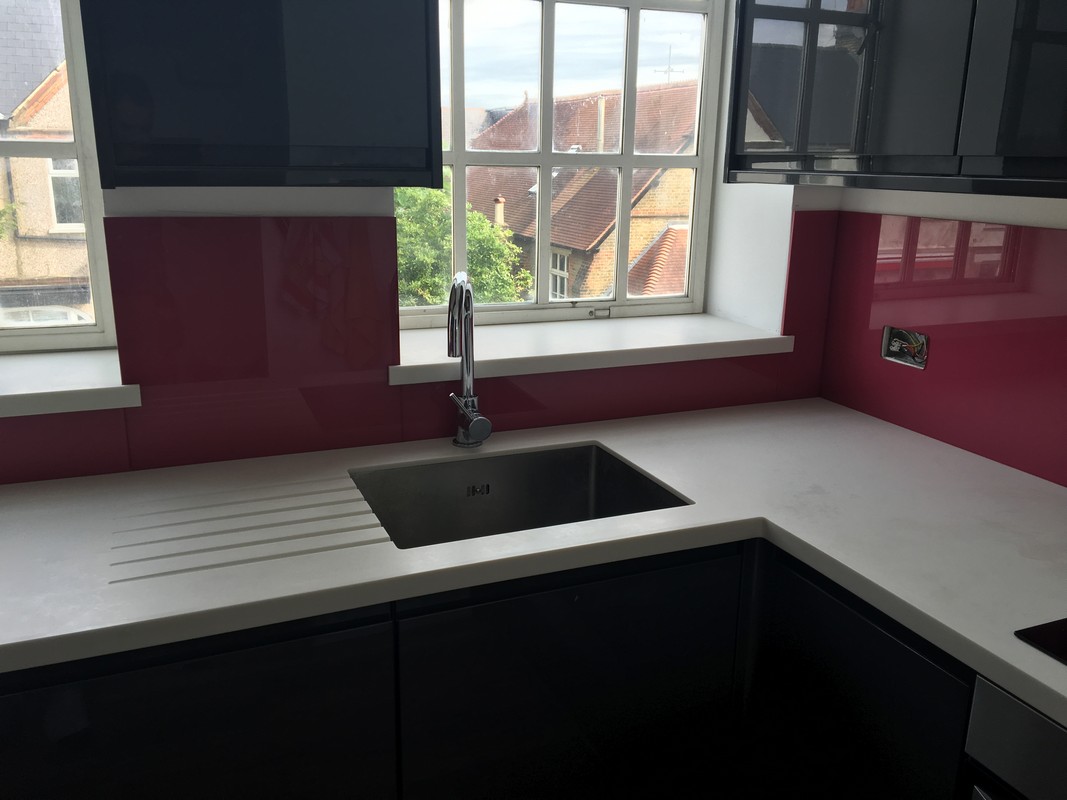 Deep plum coloured glass splashback in modern Thornton Heath kitchen